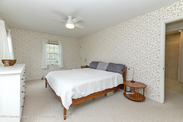 bedroom with baseboards, wallpapered walls, light carpet, and ceiling fan