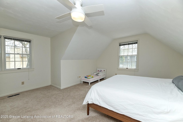 bedroom featuring ceiling fan, visible vents, vaulted ceiling, carpet floors, and baseboards