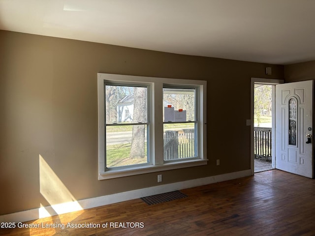 1909 W Holmes Rd, Lansing, MI 48910 - foyer entrance featuring visible vents, wood finished floors, and baseboards