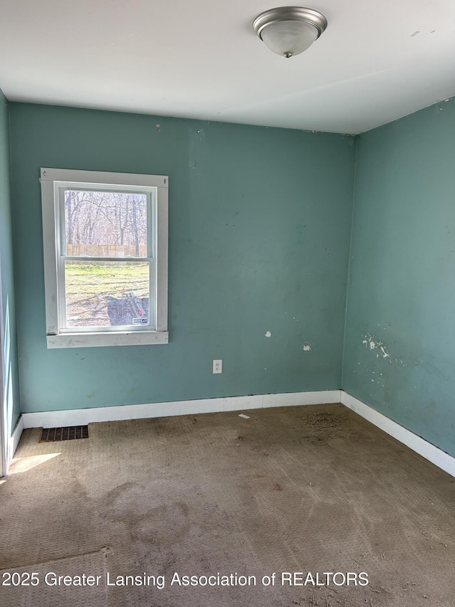 1909 W Holmes Rd, Lansing, MI 48910 - spare room featuring visible vents, baseboards, and carpet flooring