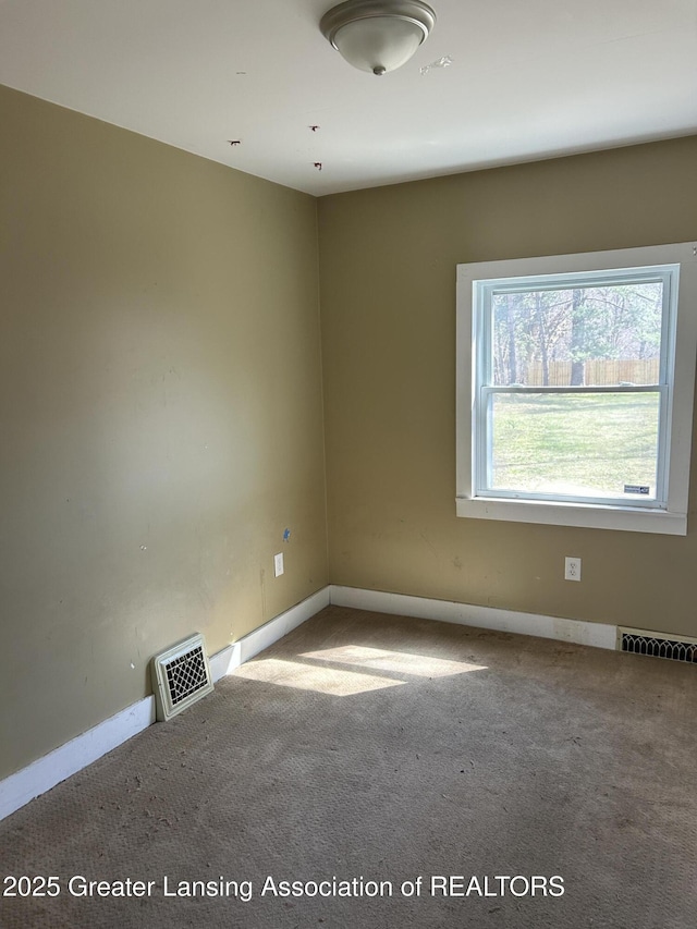 1909 W Holmes Rd, Lansing, MI 48910 - carpeted spare room with baseboards and visible vents