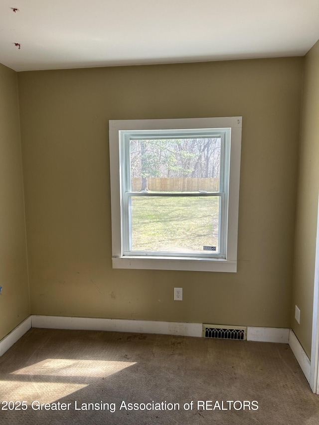 1909 W Holmes Rd, Lansing, MI 48910 - carpeted empty room featuring baseboards and visible vents