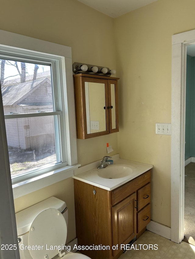 1909 W Holmes Rd, Lansing, MI 48910 - bathroom featuring toilet and vanity