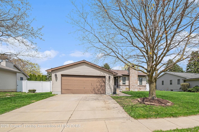 single story home with fence, a front lawn, concrete driveway, and an attached garage