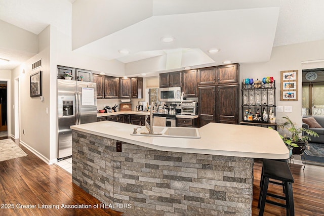 kitchen featuring dark brown cabinetry, visible vents, appliances with stainless steel finishes, and dark wood-type flooring