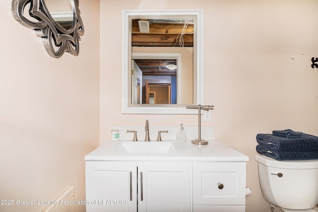 bathroom featuring toilet and vanity