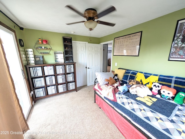 bedroom featuring a ceiling fan, carpet flooring, and a closet