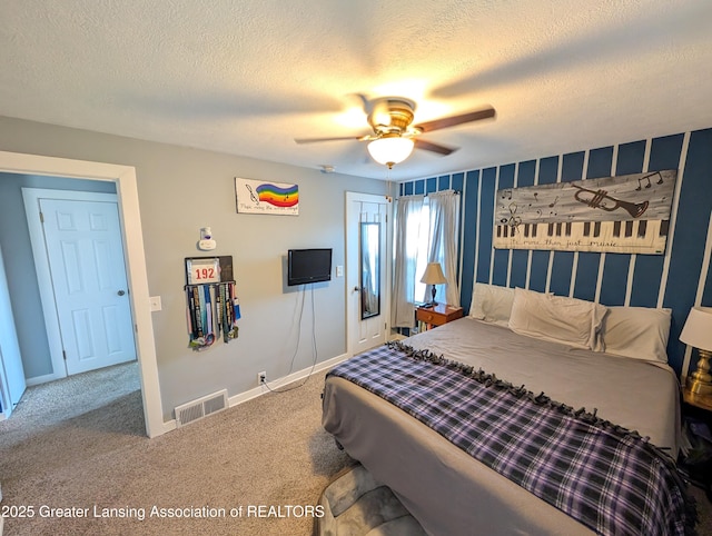 carpeted bedroom featuring a textured ceiling, visible vents, baseboards, and ceiling fan