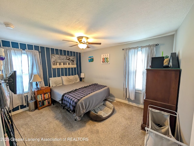 carpeted bedroom with baseboards, a textured ceiling, and ceiling fan