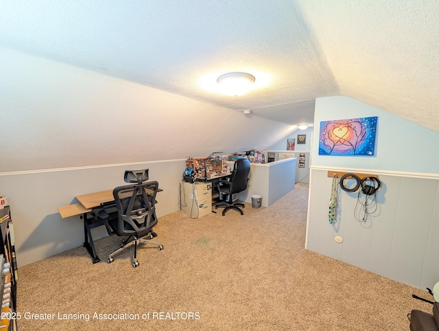 home office featuring carpet floors, lofted ceiling, and a textured ceiling