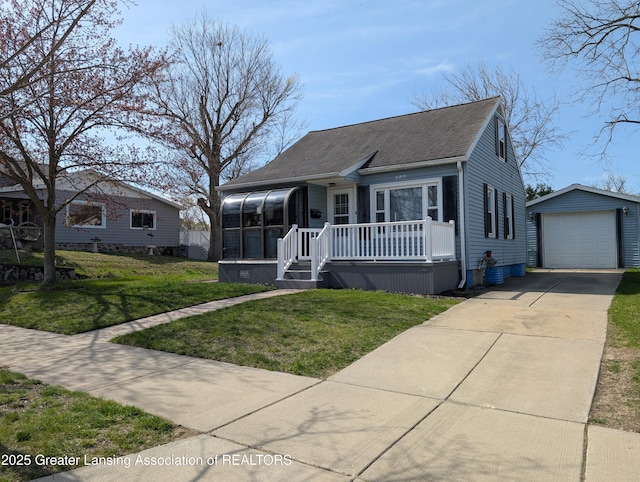 bungalow-style home featuring roof with shingles, driveway, an outbuilding, a sunroom, and a garage