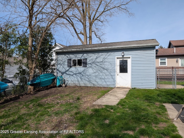 view of outbuilding with fence and an outbuilding