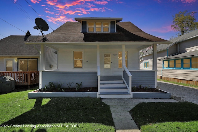 1435 New York Ave, Lansing, MI 48906 - bungalow with a front lawn and covered porch