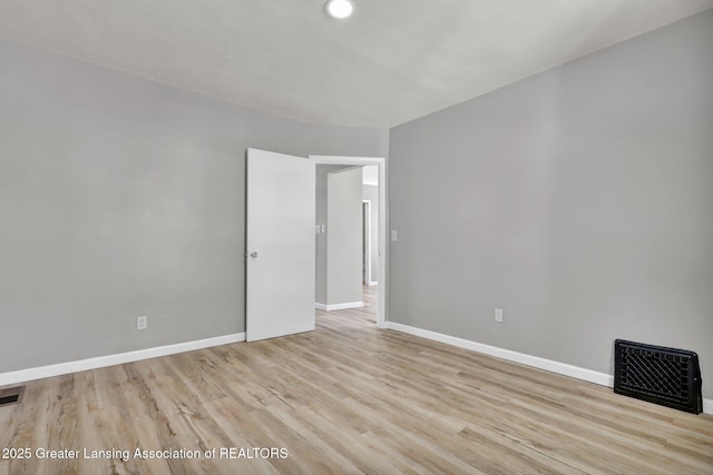 1435 New York Ave, Lansing, MI 48906 - empty room featuring baseboards, wood finished floors, and visible vents