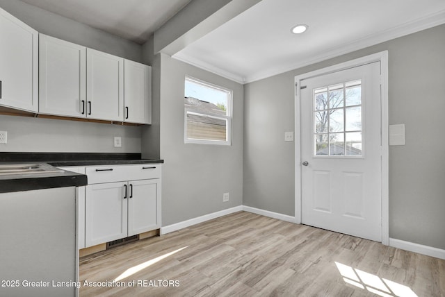 1435 New York Ave, Lansing, MI 48906 - kitchen with crown molding, baseboards, and a wealth of natural light