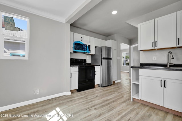 1435 New York Ave, Lansing, MI 48906 - kitchen featuring dark countertops, appliances with stainless steel finishes, a sink, baseboards, and light wood finished floors