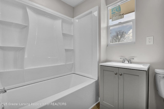 1435 New York Ave, Lansing, MI 48906 - bathroom featuring toilet, washtub / shower combination, and vanity
