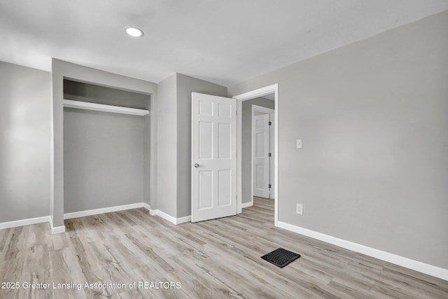 1435 New York Ave, Lansing, MI 48906 - unfurnished bedroom with visible vents, wood finished floors, baseboards, a closet, and recessed lighting