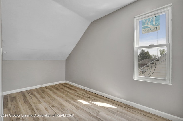1435 New York Ave, Lansing, MI 48906 - bonus room with baseboards, wood finished floors, and lofted ceiling