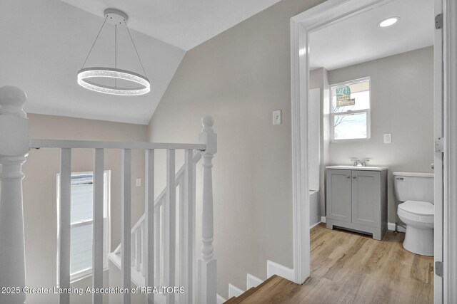 1435 New York Ave, Lansing, MI 48906 - stairs with baseboards, wood finished floors, and vaulted ceiling