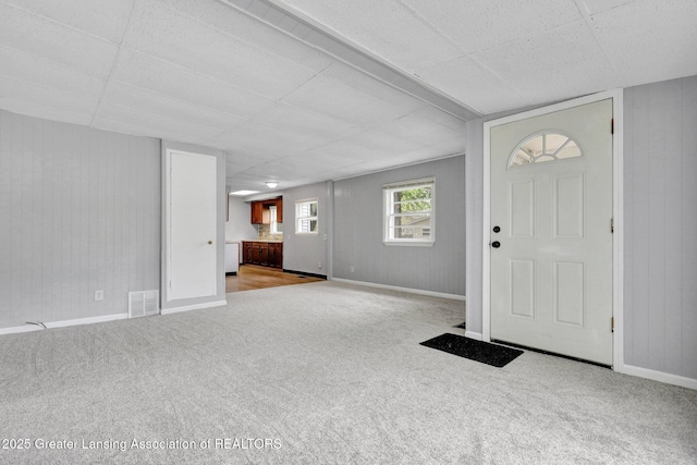218 W Thomas St, Lansing, MI 48906 - entryway featuring baseboards, a drop ceiling, visible vents, and carpet floors