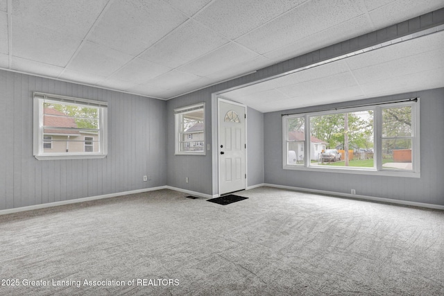 218 W Thomas St, Lansing, MI 48906 - spare room with baseboards, a drop ceiling, visible vents, and carpet floors