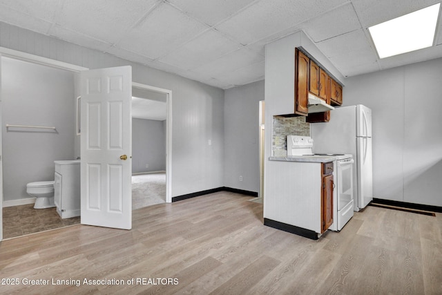 218 W Thomas St, Lansing, MI 48906 - kitchen with a paneled ceiling, brown cabinets, white electric range oven, and light wood-style floors
