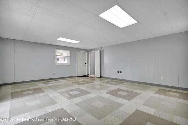 218 W Thomas St, Lansing, MI 48906 - interior space featuring a paneled ceiling, baseboards, and tile patterned floors