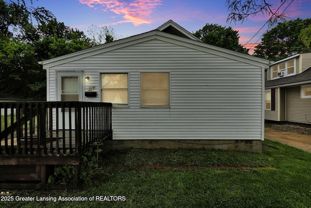 425 Filley St, Lansing, MI 48906 - rear view of house featuring a deck and a yard