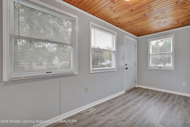 425 Filley St, Lansing, MI 48906 - foyer with ornamental molding, wood finished floors, wood ceiling, and baseboards