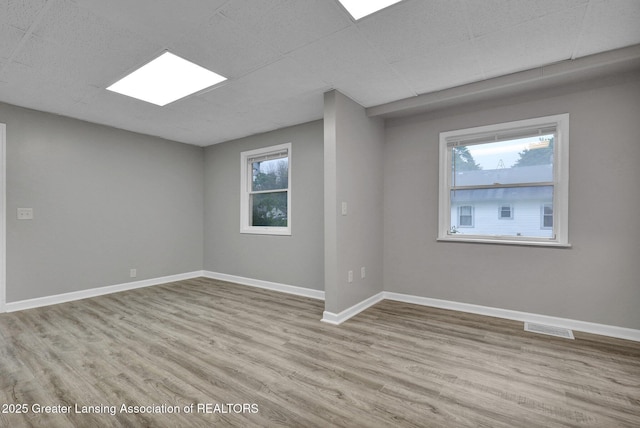 425 Filley St, Lansing, MI 48906 - unfurnished room featuring wood finished floors and baseboards