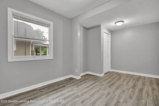 425 Filley St, Lansing, MI 48906 - spare room featuring wood finished floors and baseboards