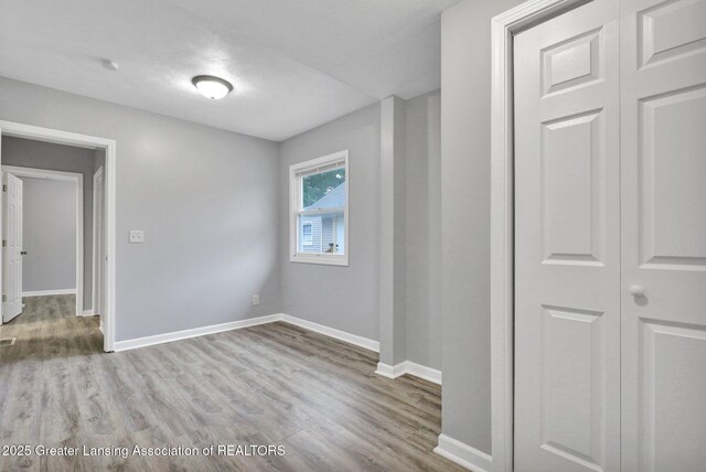 425 Filley St, Lansing, MI 48906 - empty room with wood finished floors and baseboards