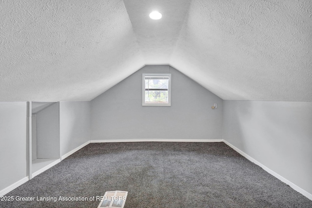 425 Filley St, Lansing, MI 48906 - bonus room featuring a textured ceiling, carpet floors, baseboards, and vaulted ceiling