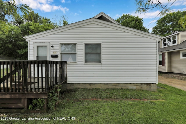 425 Filley St, Lansing, MI 48906 - rear view of property with a wooden deck and a yard