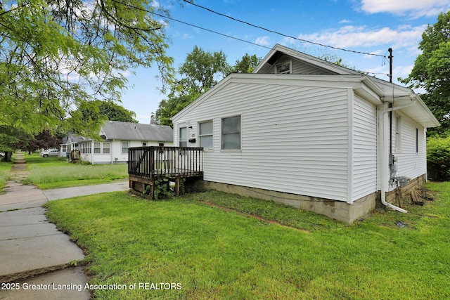 425 Filley St, Lansing, MI 48906 - view of property exterior with a wooden deck and a lawn