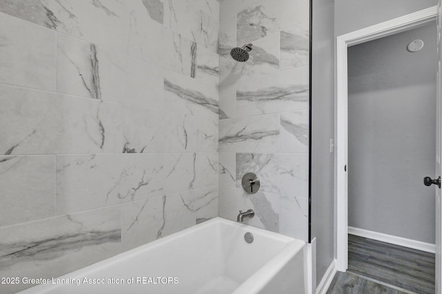 2619 Schippell St, Holt, MI 48842 - full bathroom with baseboards,  shower combination, and wood finished floors