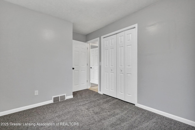 2619 Schippell St, Holt, MI 48842 - unfurnished bedroom featuring a closet, baseboards, carpet flooring, and visible vents