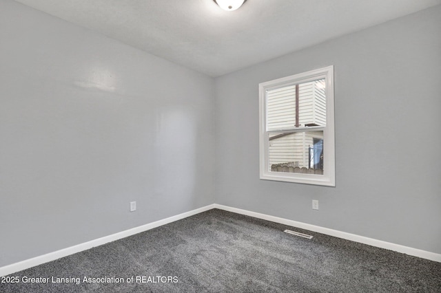 2619 Schippell St, Holt, MI 48842 - carpeted spare room with baseboards and visible vents