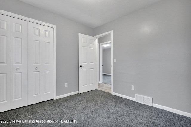 2619 Schippell St, Holt, MI 48842 - unfurnished bedroom with carpet floors, baseboards, visible vents, and a closet