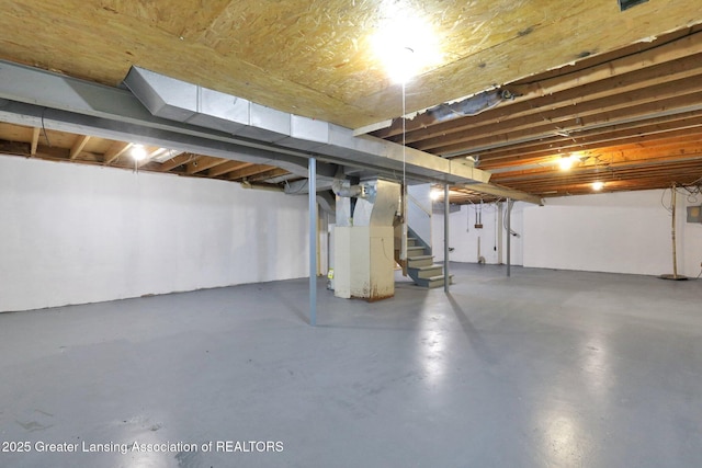 2619 Schippell St, Holt, MI 48842 - unfinished basement featuring heating unit and stairs
