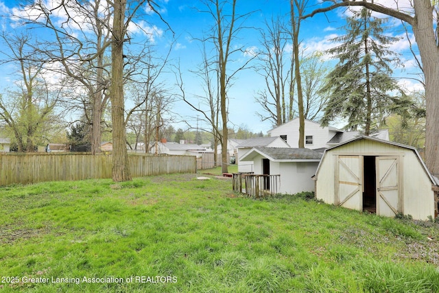 2619 Schippell St, Holt, MI 48842 - view of yard featuring an outdoor structure, fence, and a storage shed