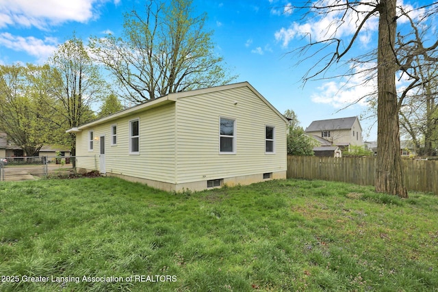2619 Schippell St, Holt, MI 48842 - view of home's exterior featuring a lawn and a fenced backyard