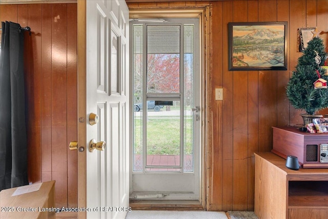 entryway with wood walls