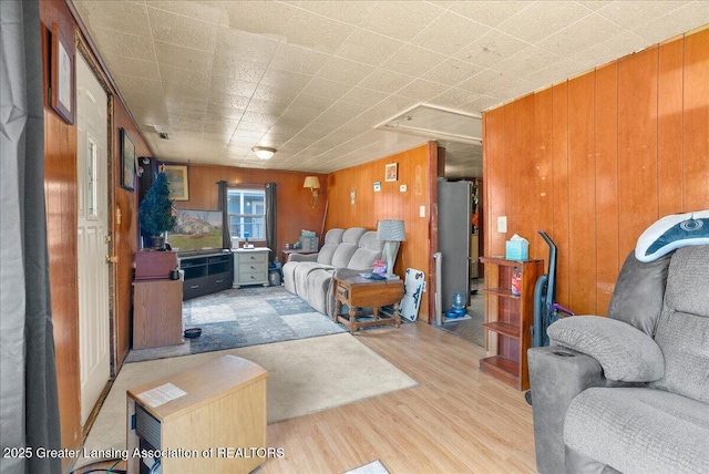 living room featuring wood finished floors and wood walls