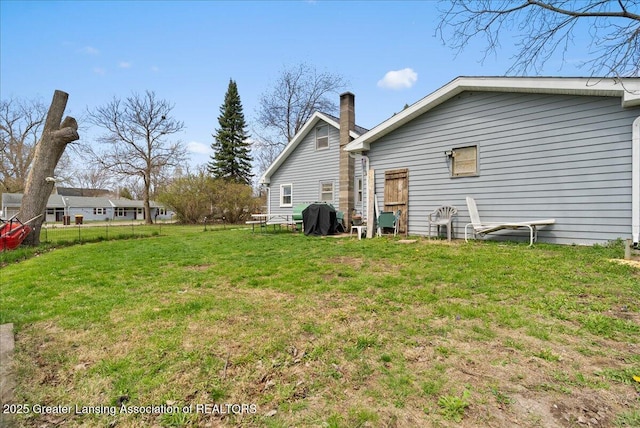 back of house with a yard