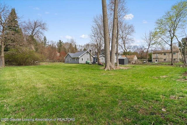 view of yard with an outbuilding and a shed