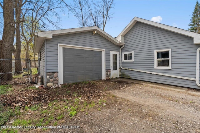 exterior space featuring driveway and fence