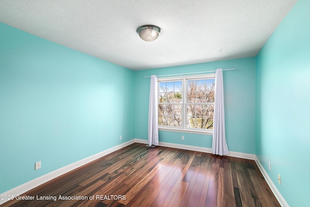12714 Ospreys Way, Dewitt, MI 48820 - unfurnished room with dark wood-style floors, a textured ceiling, and baseboards