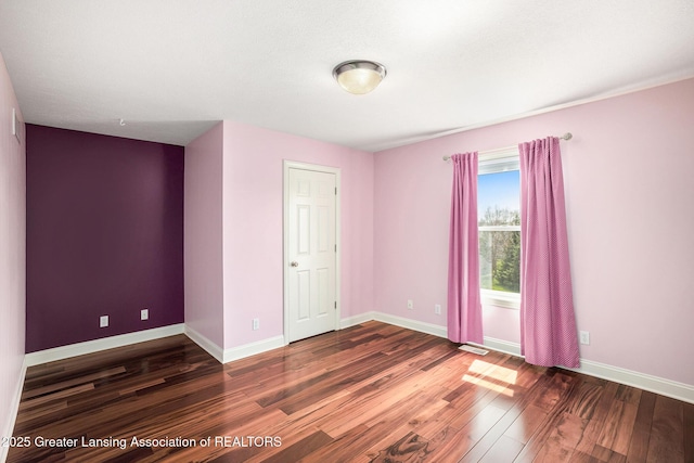 12714 Ospreys Way, Dewitt, MI 48820 - unfurnished room with baseboards, visible vents, and wood finished floors